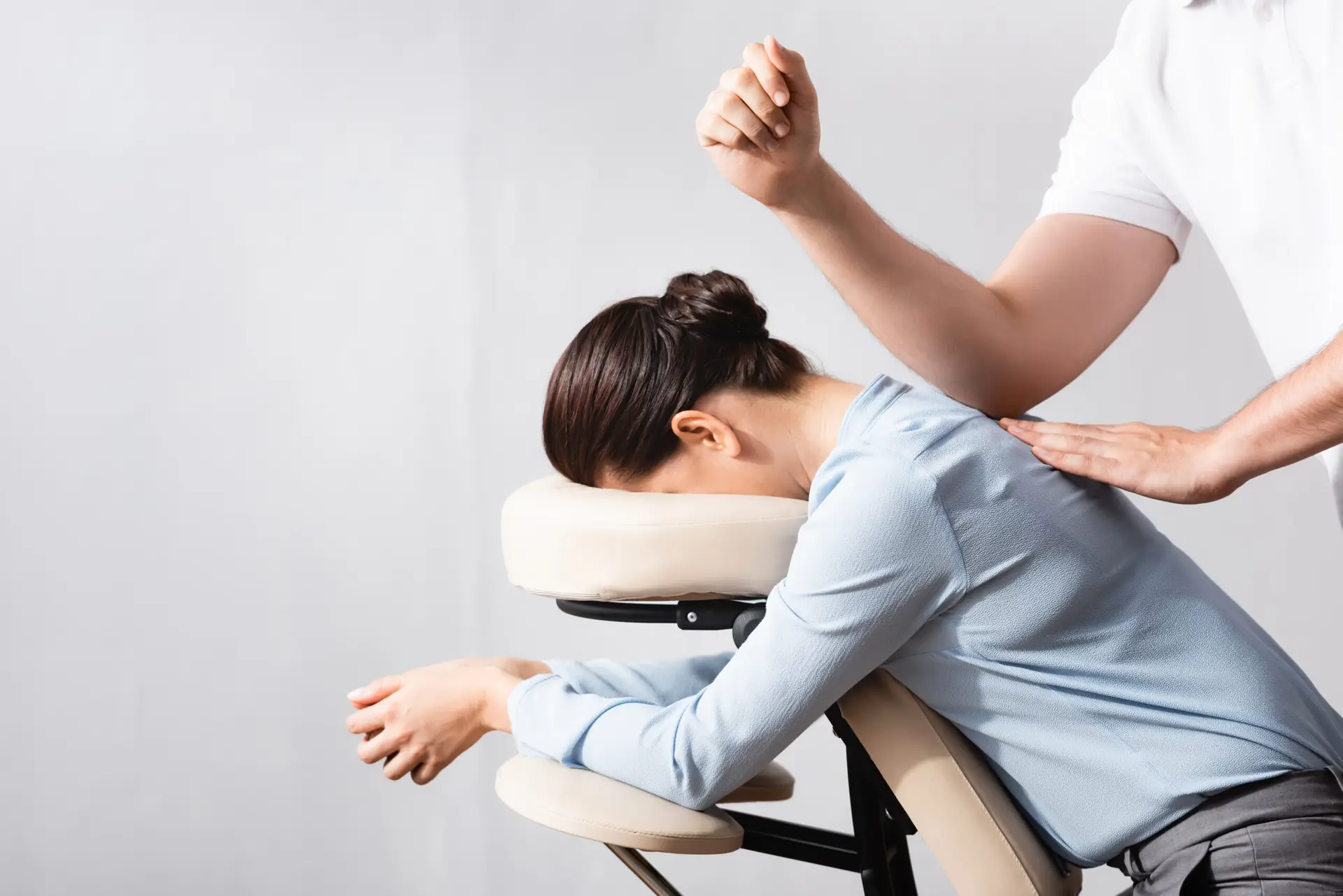 Side,View,Of,Masseur,Massaging,Woman,Back,With,Elbow,,Sitting