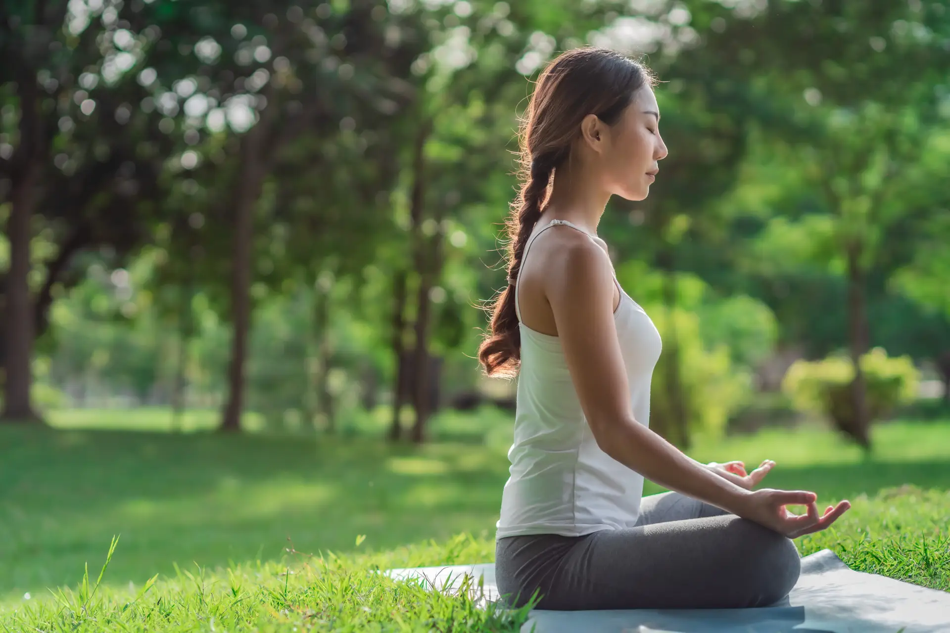 Healthy women doing yoga in the morning at the park