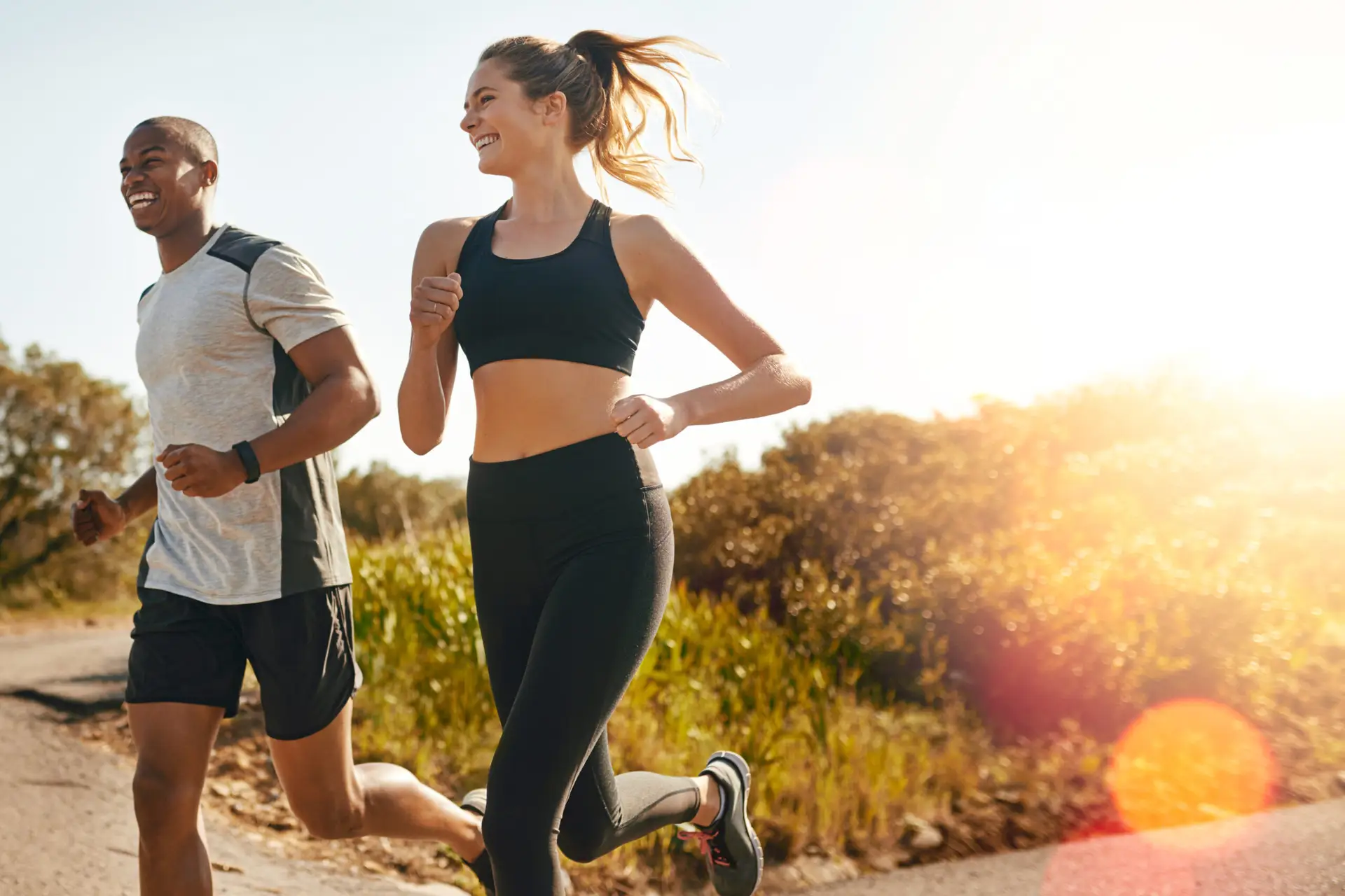 Fitness, running and health with couple in road for workout, cardio performance and summer. Marathon, exercise and teamwork with black man and woman runner in nature for sports, training and race